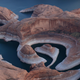 The tall bleached "bathtub ring" is visible on the rocky banks of Lake Powell at Reflection Canyon on June 24, 2021 in Lake Powell, Utah.